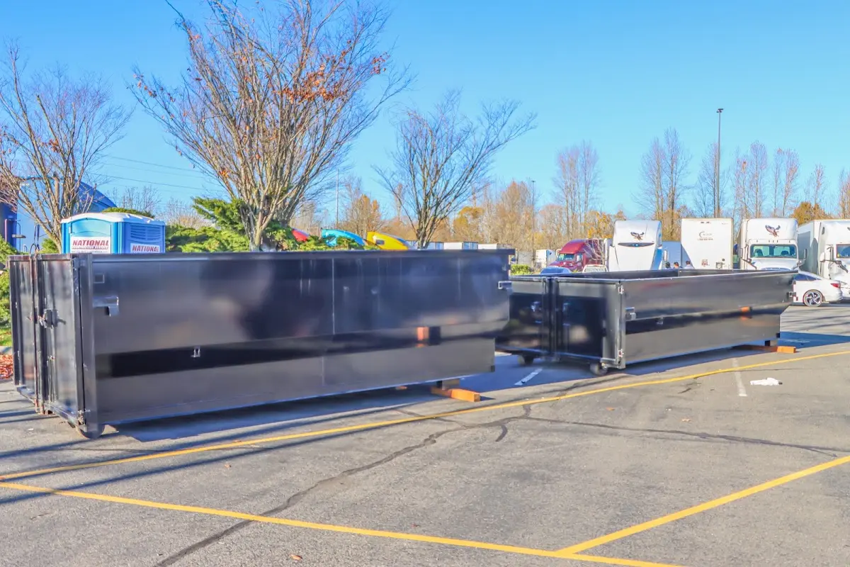 Professional dumpster rental service with roll-off container on residential driveway in Osprey